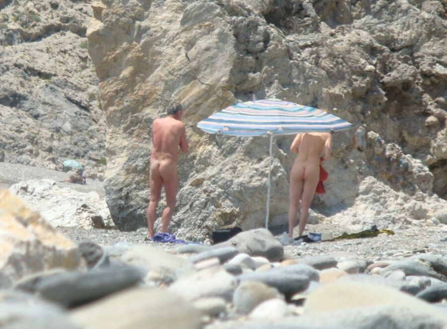 Hot young French girl spied stripping on the beach 13 of 14 pics