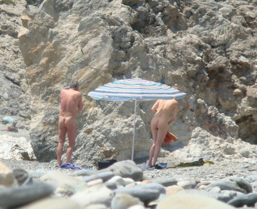 Hot young French girl spied stripping on the beach 12 of 14 pics