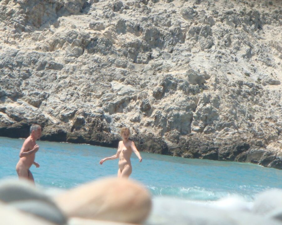 Hot young French girl spied stripping on the beach 9 of 14 pics