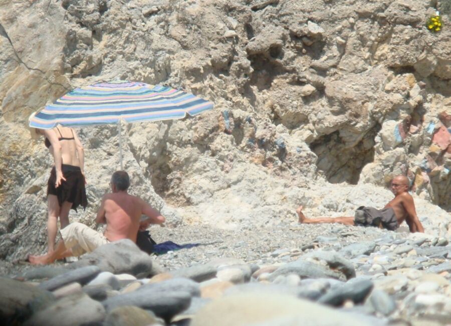Hot young French girl spied stripping on the beach 3 of 14 pics
