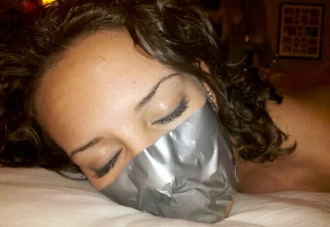 Free porn pics of Abby hogtied and asphyxiated with duct-tape. 7 of 31 pics